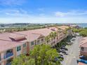 Stunning aerial view of condos with red tile roof, offering gorgeous waterfront views and convenient parking at 5000 Culbreath Key Way # 8-308, Tampa, FL 33611