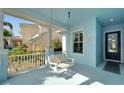 Inviting covered front porch featuring a swing, offering a relaxing outdoor space at 527 Manns Harbor Dr, Apollo Beach, FL 33572