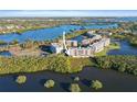 Scenic aerial view of waterfront condos surrounded by lush greenery and sparkling blue water at 6495 Shoreline Dr # 8106, St Petersburg, FL 33708