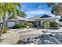Charming single-story home featuring a well-manicured lawn and a driveway with decorative concrete accents at 6603 Seabird Way, Apollo Beach, FL 33572