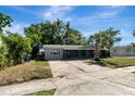 Attractive single-story home featuring a driveway and lush landscaping at 7101 Kingston Dr, Tampa, FL 33619