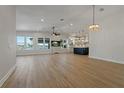 Bright, open-concept living area with wood floors, water views, and seamlessly connected kitchen at 714 Bayshore Dr, Tarpon Springs, FL 34689