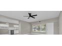 Inviting living space featuring a black ceiling fan, neutral walls, and a view of the kitchen at 10426 109Th St, Seminole, FL 33778