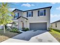 Beautiful two-story home with well-manicured landscaping and attached two-car garage at 11828 Miracle Mile Dr, Riverview, FL 33578