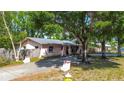 A charming single-story home with a long driveway, complemented by mature trees and well-kept landscaping at 15204 Westminister Ave, Clearwater, FL 33760