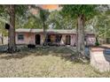 Charming single-story home with mature trees and a well-kept front yard, featuring arched doorways at 15204 Westminister Ave, Clearwater, FL 33760