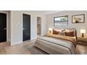 Comfortable bedroom showcasing an ensuite bathroom and large window allowing natural light at 1981 Briarwood St, Dunedin, FL 34698