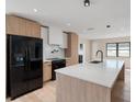 Bright, open kitchen with stainless steel appliances, white countertops, and wooden cabinets at 1981 Briarwood St, Dunedin, FL 34698