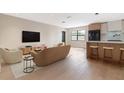 Bright and modern living room featuring hardwood floors and an open floor plan to the kitchen at 1981 Briarwood St, Dunedin, FL 34698