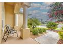 Inviting front porch with comfortable seating and a view of the lush landscaping and sunny neighborhood at 2218 132Nd E Pl, Parrish, FL 34219