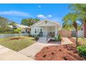 Inviting single-story home showcasing a landscaped yard, brick walkway, and a covered front porch at 2328 Dartmouth N Ave, St Petersburg, FL 33713