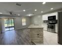 Open kitchen featuring stainless appliances, granite counters and access to the back porch at 2520 Edgewater Falls Dr, Brandon, FL 33511