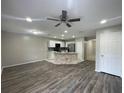Spacious living room and kitchen combo, with modern appliances and a ceiling fan at 2520 Edgewater Falls Dr, Brandon, FL 33511