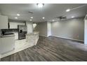 Bright and airy living room with modern flooring, stainless appliances, and ceiling fan at 2520 Edgewater Falls Dr, Brandon, FL 33511