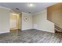 Open-concept living area boasting sleek tile flooring, neutral walls, and a staircase leading to the upper level at 263 Alexander Woods Dr, Plant City, FL 33563