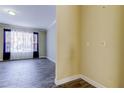 Light-filled living area featuring stylish tile flooring, neutral paint, and large window with sheer and black-out curtains at 263 Alexander Woods Dr, Plant City, FL 33563