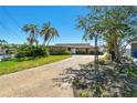 A charming home featuring a stone facade, spacious driveway, and well-maintained landscaping at 2970 68Th S Ave, St Petersburg, FL 33712