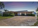 A charming home featuring a stone facade, spacious driveway, and well-maintained landscaping at 2970 68Th S Ave, St Petersburg, FL 33712