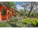 Inviting porch with decorative accents and lush tropical landscaping at 33357 Westwood Dr, Ridge Manor, FL 33523