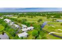 Aerial view of condos near a golf course, ponds, and lush green landscape at 367 Bobby Jones Rd # 367, Sarasota, FL 34232