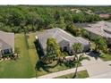 Expansive aerial shot of a single-Gathering home, showcasing the lush backyard and manicured landscaping at 5409 Conch Shell Pl, Apollo Beach, FL 33572