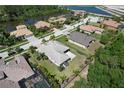 Stunning aerial view of homes in a community near a lake, featuring well-maintained lawns and tile roofs at 5409 Conch Shell Pl, Apollo Beach, FL 33572