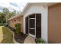 Exterior view of the front entrance and the screened-in entry, showcasing the front door at 5664 Legend Hills Ln, Spring Hill, FL 34609