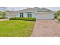 Attractive single story home with a brick driveway and a well maintained lawn at 604 Mcdaniel St, Sun City Center, FL 33573