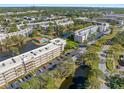 Gorgeous aerial view of the condo community featuring lake views and multiple swimming pools at 6070 80Th N St # 104, St Petersburg, FL 33709