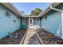 Front entry way leading to a charming front door with decorative glass at 7101 Channelside N Ln, Pinellas Park, FL 33781