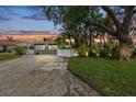 Charming home featuring a landscaped front yard, mature trees, and a well-maintained driveway at 7912 3Rd S Ave, St Petersburg, FL 33707