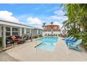 Backyard pool with patio area including seating and lounge chairs, perfect for relaxing and entertaining at 7912 3Rd S Ave, St Petersburg, FL 33707