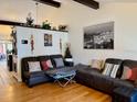 Cozy living room with a large sectional sofa, hardwood floors, and a half wall with decor at 804 Valley Hill Ct, Brandon, FL 33510