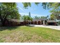 Front lawn of home with garage and circular driveway, manicured landscaping at 8820 S Hickory Ln, Riverview, FL 33578