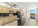 Modern kitchen features stainless steel appliances, ample cabinetry, and easy access to a balcony with beautiful views at 9415 Blind Pass Rd # 704, St Pete Beach, FL 33706