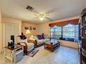 Cozy living room featuring tile floors, large window, and comfortable seating at 1102 Springtime Dr, Holiday, FL 34691