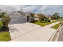 Well-maintained single-story home with a wide driveway, a two-car garage, and a beautifully landscaped front yard at 11335 77Th E St, Parrish, FL 34219