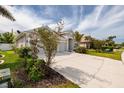Charming single-story home featuring a long driveway, a two-car garage, and mature landscaping at 11335 77Th E St, Parrish, FL 34219