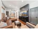 Cozy living room featuring hardwood floors, a comfortable sectional, and stylish decor at 114 E Emily St, Tampa, FL 33603