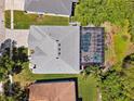 Aerial view of property with private pool and screened enclosure amidst lush landscaping and mature trees at 12308 Bramfield Dr, Riverview, FL 33579