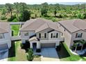 Two-story home showing an elevated perspective that highlights the roof and siding details, with a landscaped front yard at 12841 Wildflower Meadow Dr, Riverview, FL 33579
