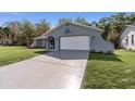 Charming single-story home with a well-manicured lawn and a two-car garage at 13501 Whitby Rd, Hudson, FL 34667