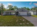 Charming single-story home with a well-manicured lawn and a two-car garage at 13501 Whitby Rd, Hudson, FL 34667