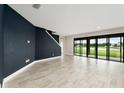 Open living room with sliding glass doors that overlook the lake at 14403 Woodland Spur Dr, Lithia, FL 33547