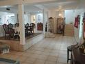 Open-concept living area with tile flooring, pillars and adjacent dining space at 14633 Sassandra Dr, Odessa, FL 33556