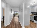 Hallway view showing hardwood floors, leading to the living area with a view and the nearby kitchen at 1901 Oyster Catcher Ln # 823, Clearwater, FL 33762