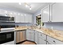 The kitchen features granite countertops, updated appliances, and ample cabinet space at 1901 Oyster Catcher Ln # 823, Clearwater, FL 33762