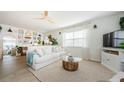 Cozy living room featuring a comfortable white sofa, stylish decor, and ample natural light from a large window at 2261 Queen S St, St Petersburg, FL 33712