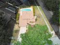 Aerial view of a home with a large in-ground kidney-shaped swimming pool in the backyard at 3103 Taragrove Dr, Tampa, FL 33618