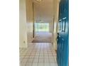 Bright tiled foyer leading into a carpeted living space with a sliding glass door to a lanai at 3629 Indigo Pond Dr # 3629, Palm Harbor, FL 34685